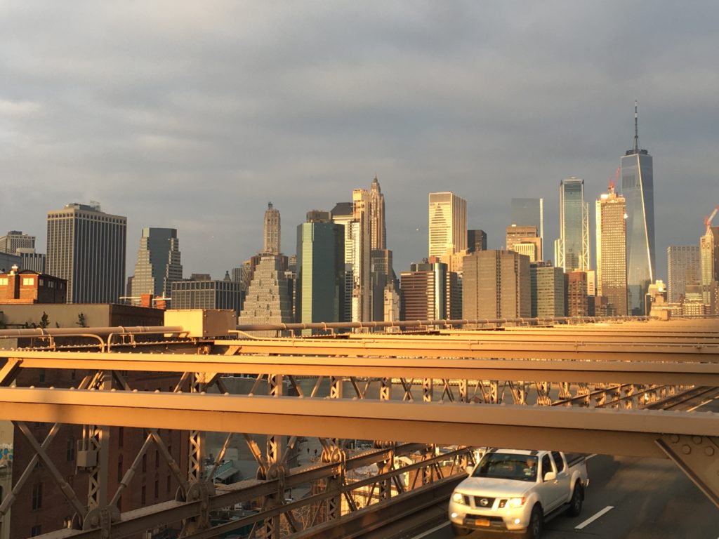 Early-morning sunlight brightens the World Trade Center’s facade, seen from the Brooklyn Bridge’s pedestrian and cyclist pathway. Photo: Lore Croghan/Brooklyn Eagle