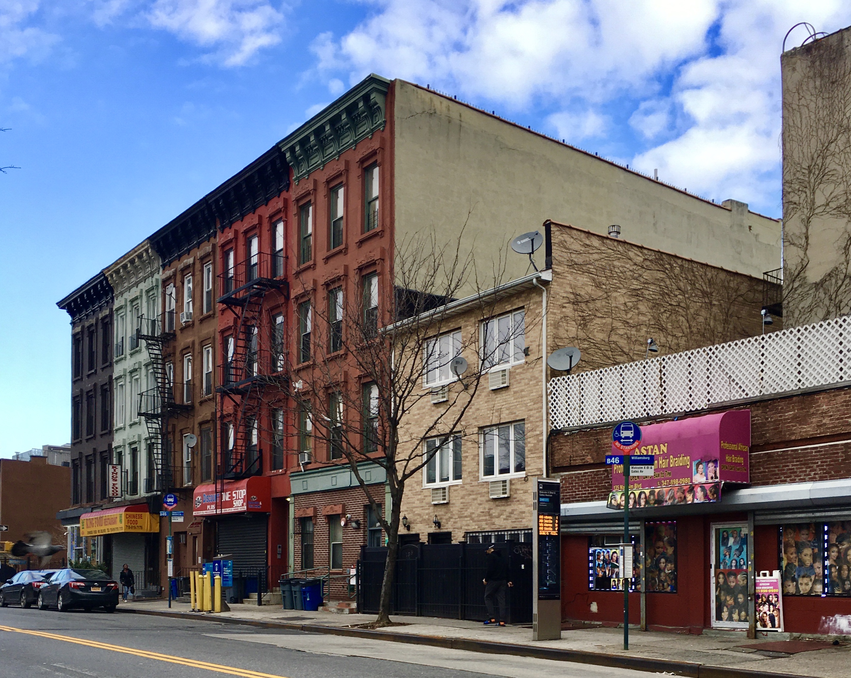 You can see these Malcolm X Boulevard rowhouses from the corner of Gates Avenue. Photo: Lore Croghan/Brooklyn Eagle
