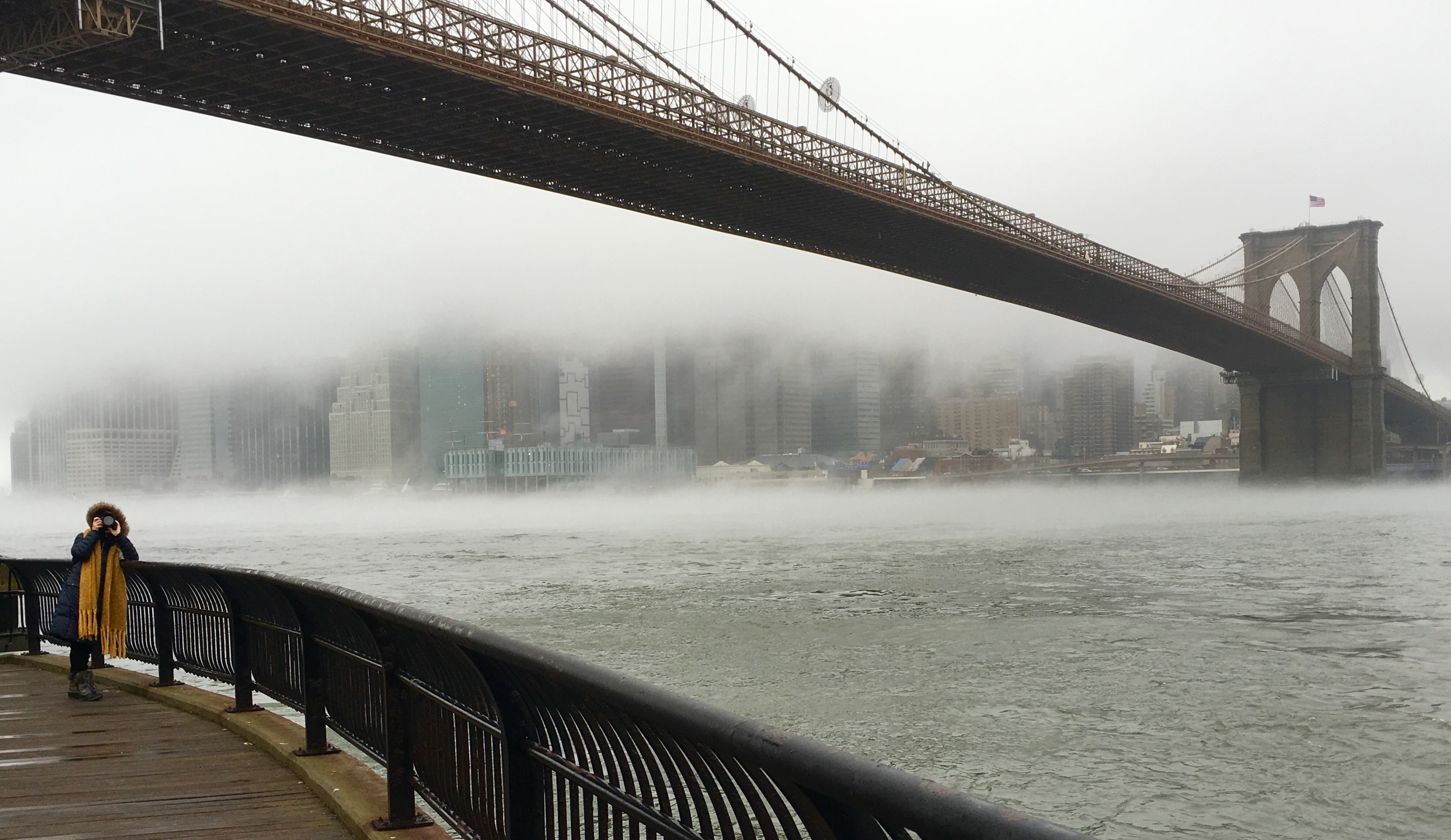 Wintry fog swirls around the Brooklyn Bridge. Photo: Lore Croghan/Brooklyn Eagle