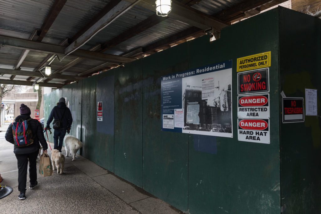 Pedestrians make their way through a makeshift tunnel created by a sidewalk shed in Brooklyn Heights in 2020. Photo: Paul Frangipane/Brooklyn Eagle