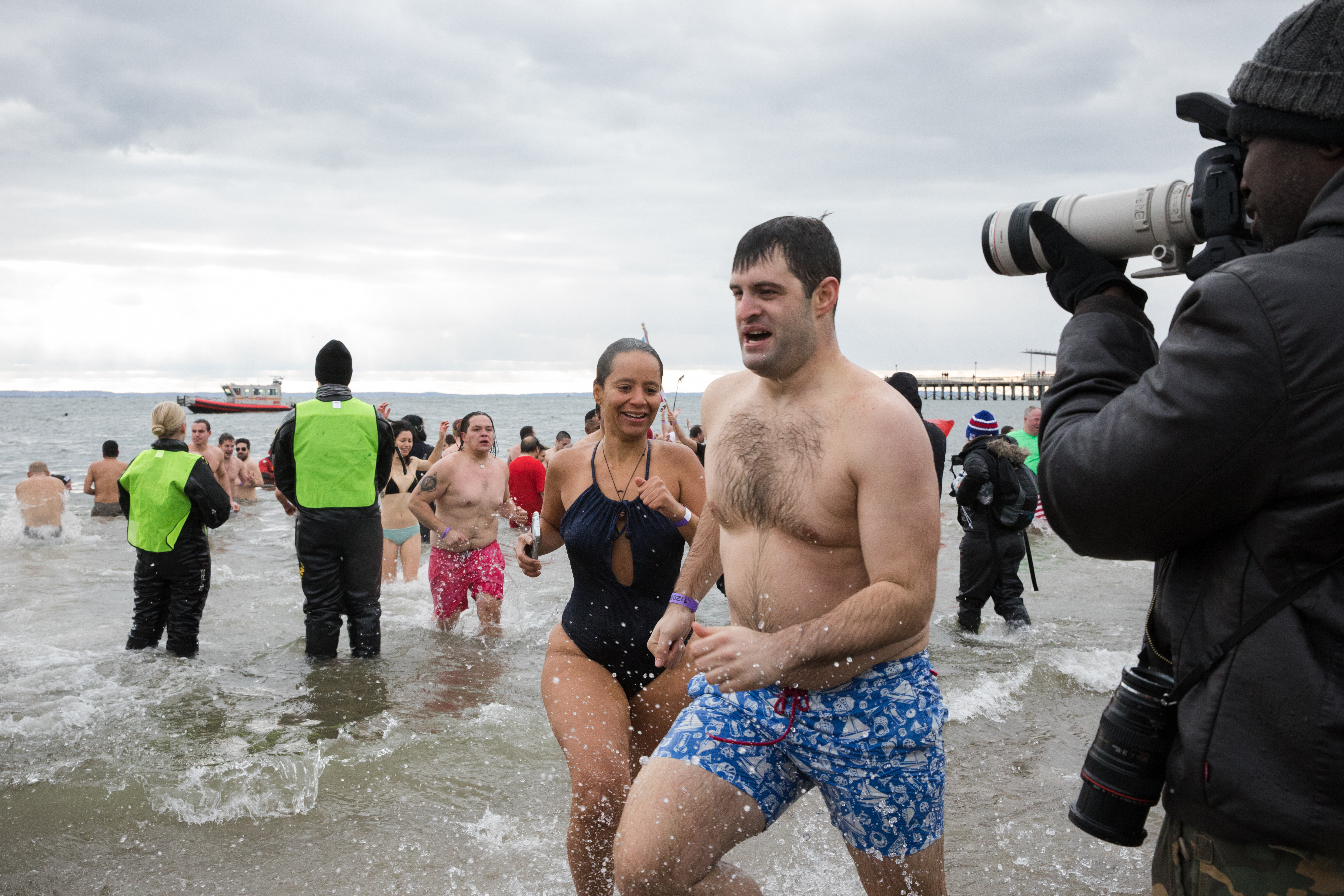 The Polar Plunge attracts hordes of photographers, some brave enough to get into the chilly ocean alongside the swimmers.