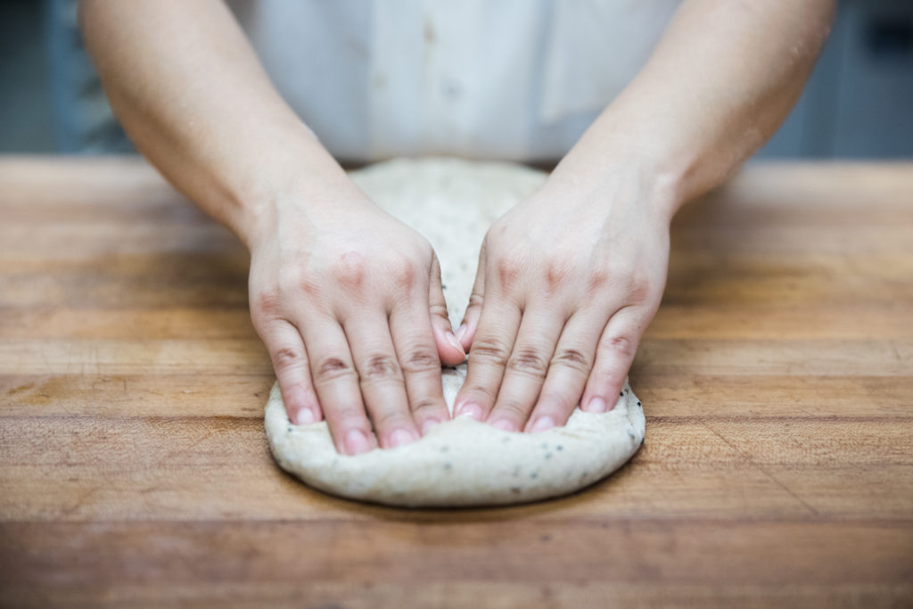A baker’s hands at Russ & Daughters manufacturing facility in the Brooklyn Navy Yard. Photo: Paul Frangipane/Brooklyn Eagle