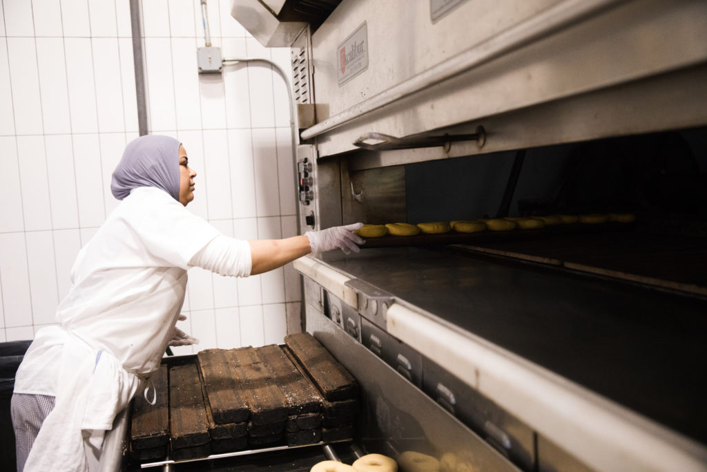 Bagels go into the oven at Russ & Daughters’ Navy Yard facility. Photo: Paul Frangipane/Brooklyn Eagle