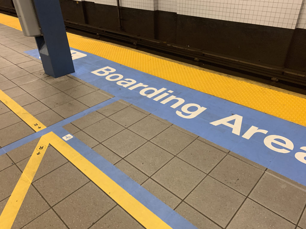 This platform at the Jay St/MetroTech subway station in Downtown Brooklyn has colorful way-finding stripes, bumpy tactile guideways and boarding area floor markers as part of a test of aids for disabled riders. Photo: Meaghan McGoldrick/Brooklyn Eagle