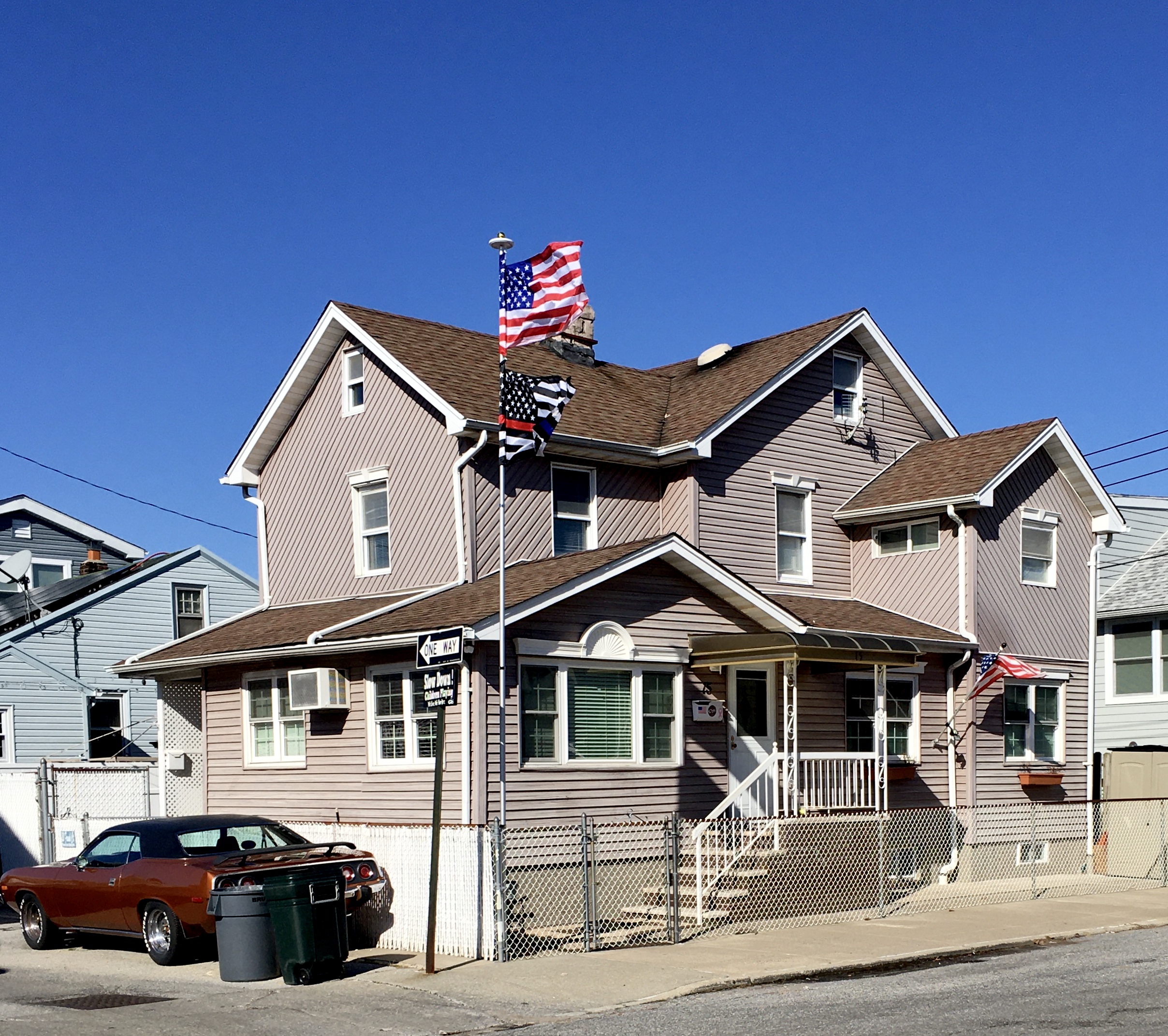 Flags are flying on the corner of Frank Court and Lois Avenue. Photo: Lore Croghan/Brooklyn Eagle