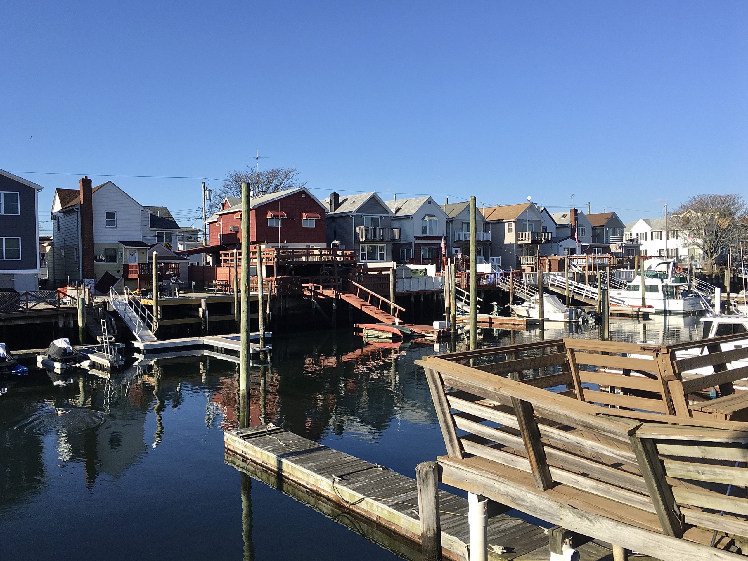 These Gotham Avenue houses have docks on Shell Bank Canal. Photo: Lore Croghan/Brooklyn Eagle