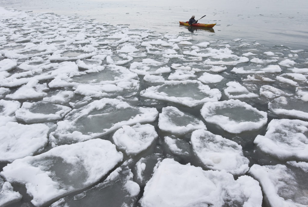 MICHIGAN — Frigid waters: A kayaker paddled past a field of ice off the shores of St. Joseph. Photo: Don Campbell/The Herald-Palladium via AP