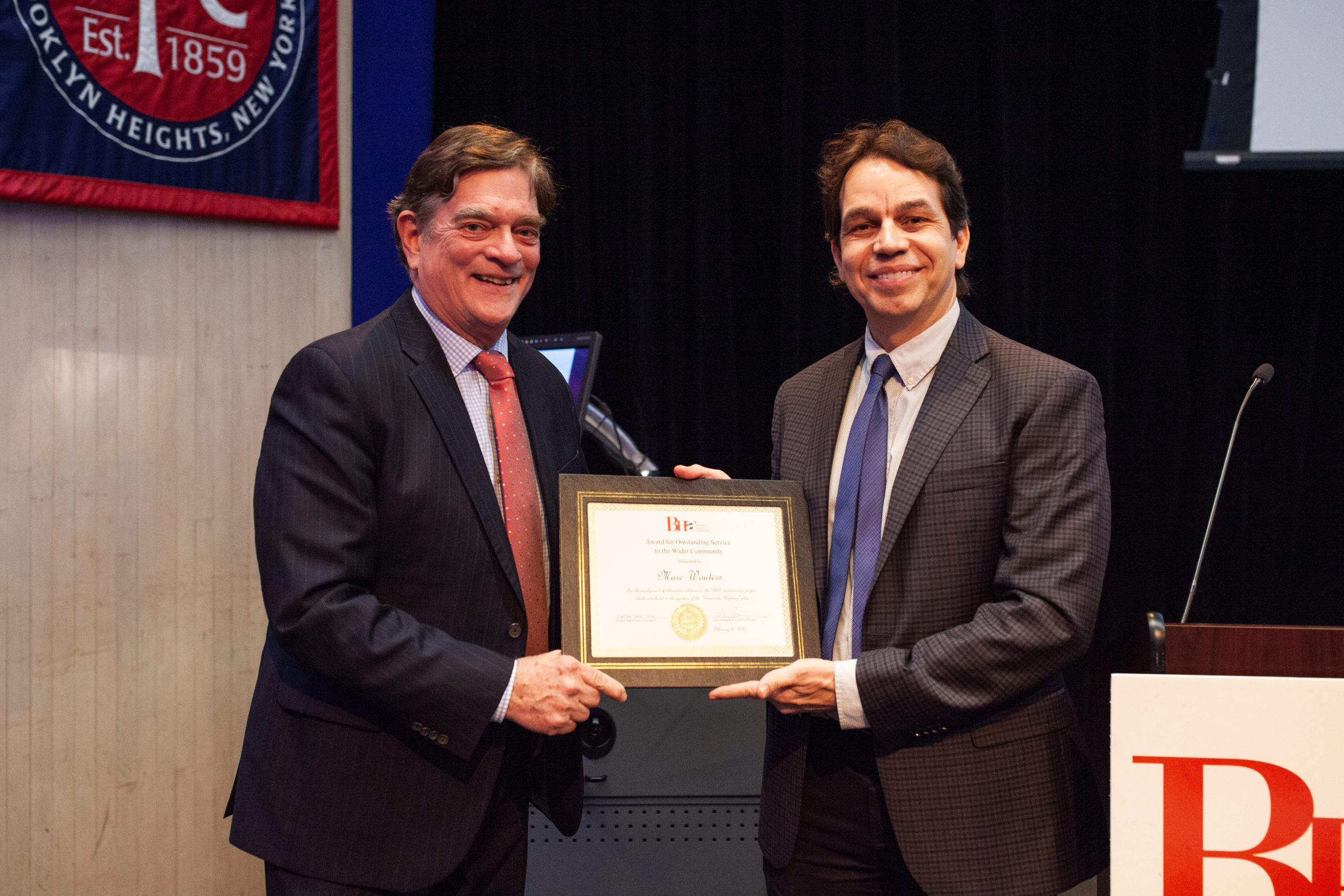 Tom Stewart, left, presents a community service award to Marc Wouters of Marc Wouters Studio at the Brooklyn Heights Association Annual meeting on Feb. 26, 2020 at St. Francis College. Wouters contributed to the idea process for the Brooklyn-Queens Expressway repair. Photo: Paul Frangipane/Brooklyn Eagle