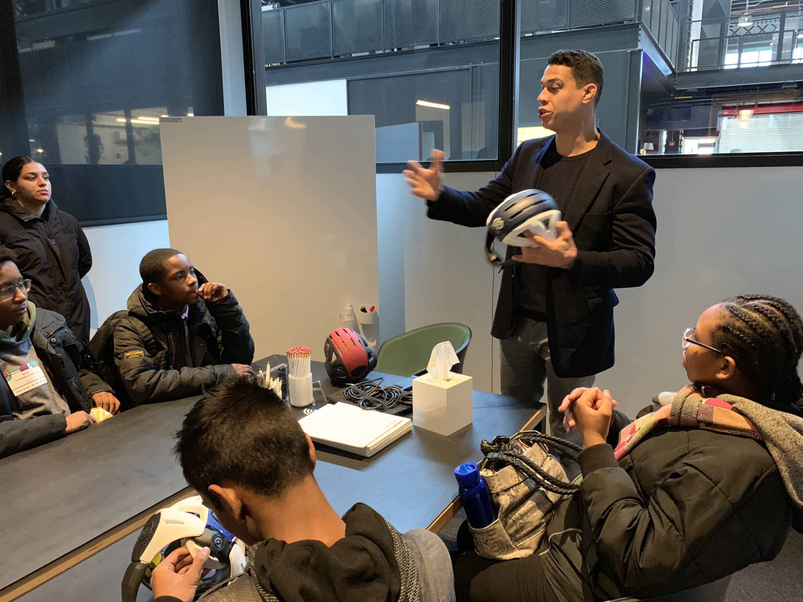 Mario Mercado describes the jobs involved in his helmet company, Bats-toi, at the Career Discovery Week event at the Brooklyn Navy Yard. Photo: Mary Frost, Brooklyn Eagle