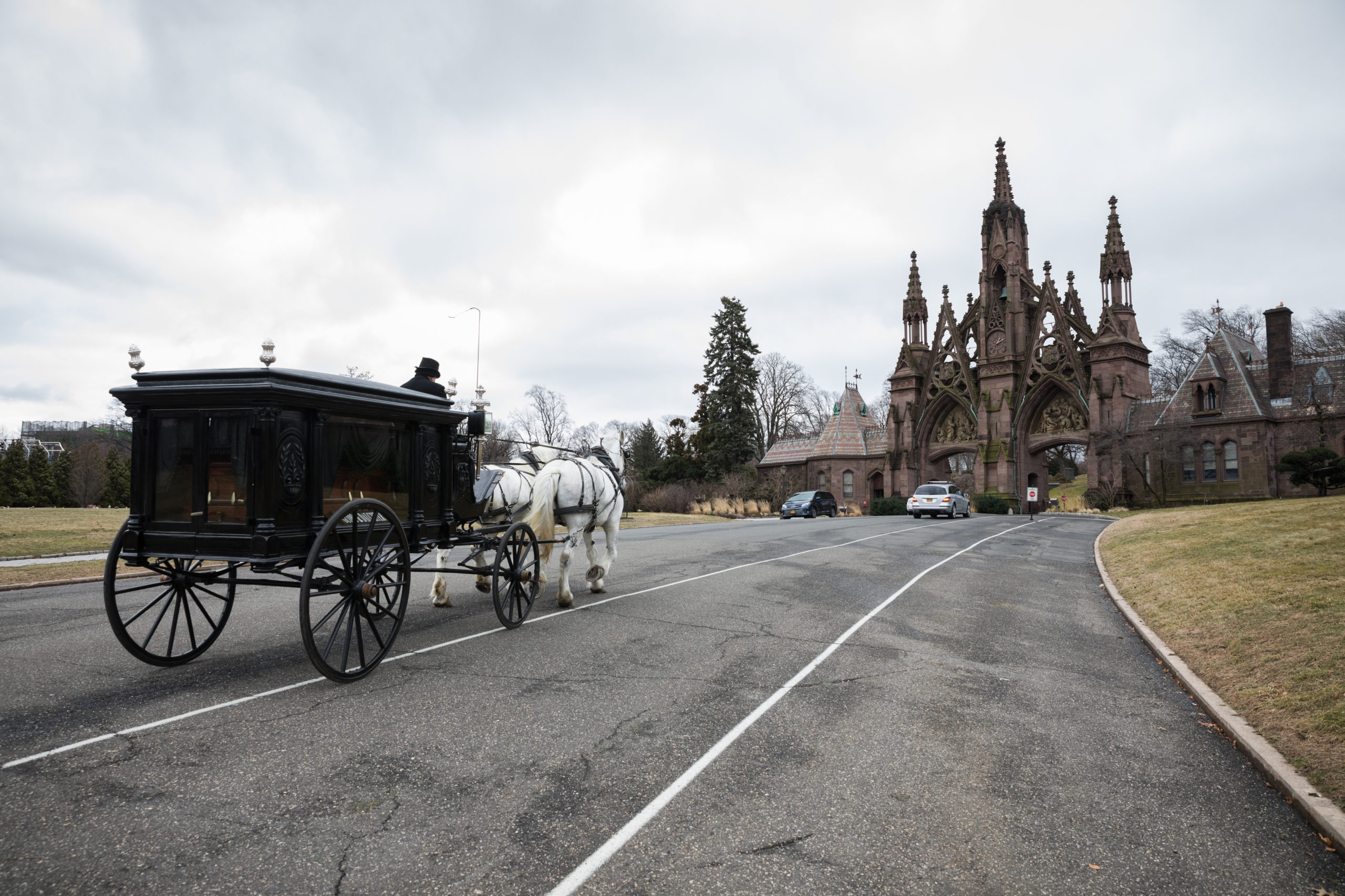 The two Percheron horses make their way up the hill to the gates of Green-Wood Cemetery for the final stop of the funeral procession. 