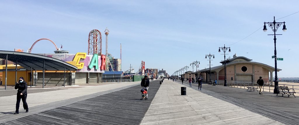 The woman at left wears a protective mask on the Coney Island Boardwalk. Photo: Lore Croghan/Brooklyn Eagle