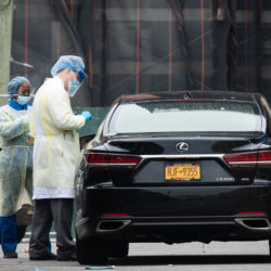 A health care worker prepares to swab a patient's nasal cavity for a COVID-19 test at Brooklyn's first drive-through testing facility in Coney Island on March 20, 2020. Photo: Paul Frangipane/Brooklyn Eagle
