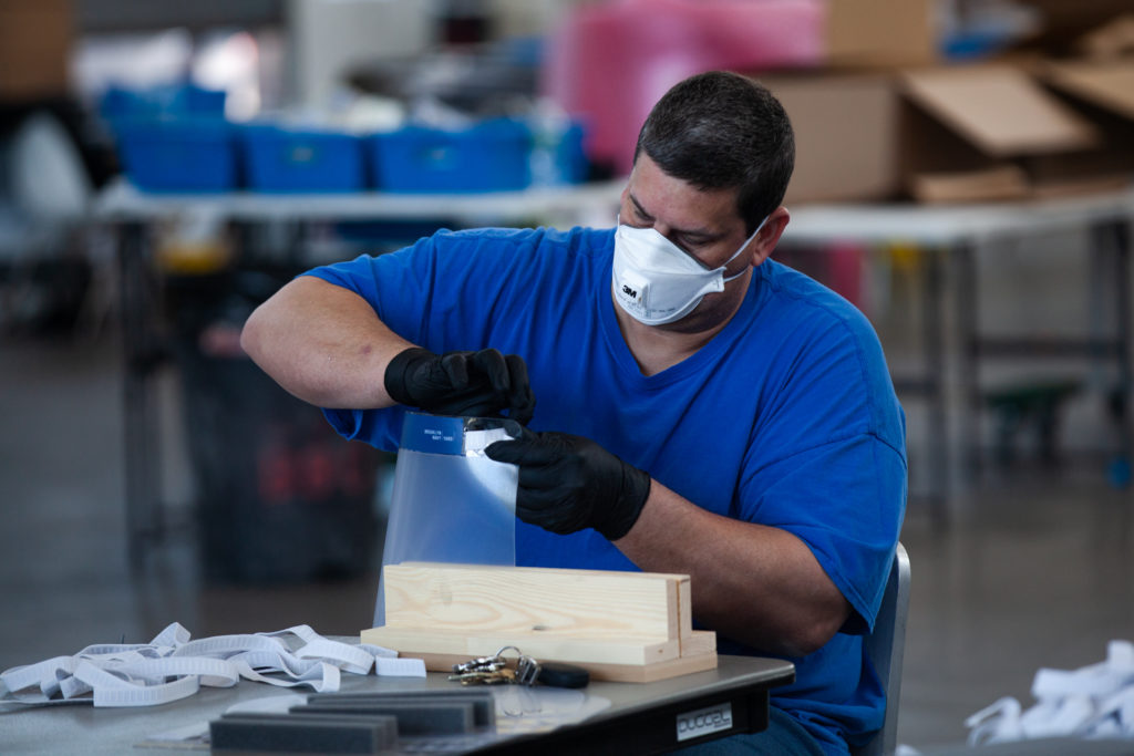 Industrial firms Duggal Visual Solutions and Bednark are using their spaces in the Brooklyn Navy Yard to manufacture personal protective equipment for local hospitals. Company workers built face shields in the warehouse on March 26, 2020. Photo: Paul Frangipane/Brooklyn Eagle