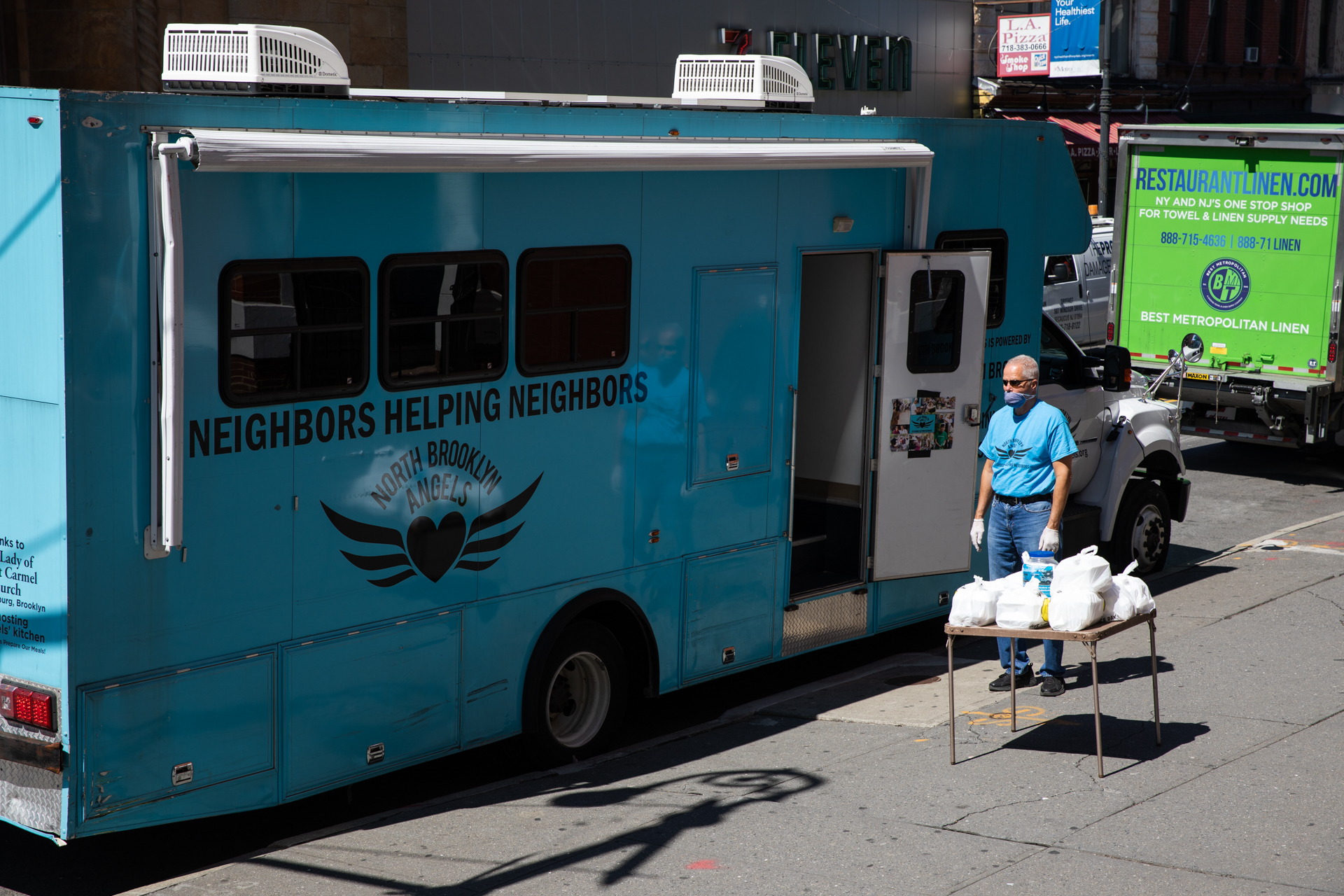 One of the most important aspects of the North Brooklyn Angels, their Angelmobile, cannot be used at it once was. Instead of getting food from the vehicle's service window, passersby have to pick up pre-packaged meals from a table on the sidewalk, due to social distancing rules. Photo: Paul Frangipane/Brooklyn Eagle