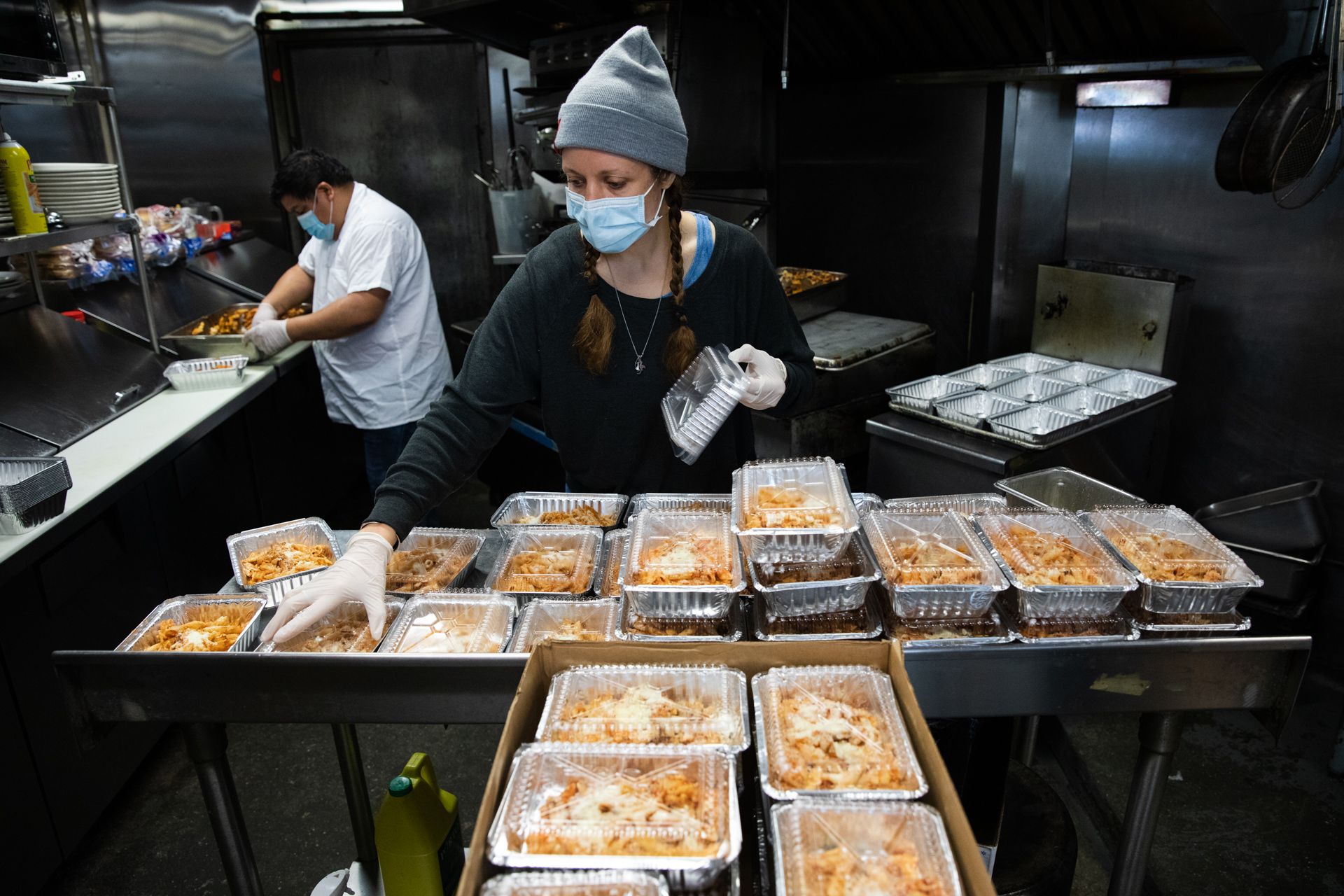 Blair Papagni, owner of Jimmy's Diner, packages baked ziti with her kitchen staff for a dinner delivery to health care workers at Woodhull Hospital. Photo: Paul Frangipane/Brooklyn Eagle
