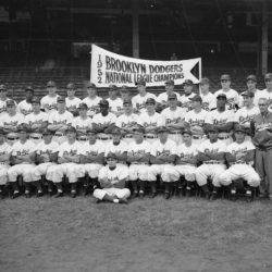The Brooklyn Dodgers, National League champions, pose for a team photo, Sept. 26, 1952, at Ebbets Field, Brooklyn. Seated on ground: Charlie Di Giovanna. Seated in first row, from left: George Shuba, Andy Pafko, Pee Wee Reese, George Pfister, Cookie Lavagetto, Chuck Dressen, Jake Pitler, Billy Herman, Billy Cox, Roy Campanella, Carl Furillo, Dr. Harold Wendler. Second row: John Griffin (in T-shirt), Lee Scott (in suit), Jim Hughes, Gil Hodges, Ben Wade, Johnny Rutherford, Jackie Robinson, Clem Labine, Clyde King, Chris van Cuyk, Preacher Roe, Joe Black, Ralph Branca, Rocky Nelson. Last row: Joe Landrum, Ed Amoros, Rube Walker, Carl Erskine, Bobby Morgan, Tommy Holmes, Rocky Bridges, Billy Loes, Duke Snider, Dick Williams, Ken Lehman, Ronnie Negray, Steve Lembo, Ray Moore.