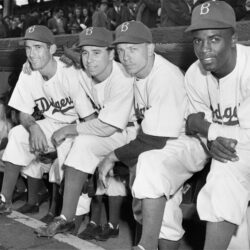In this April 15, 1947, file photo, Brooklyn Dodgers baseball players, from left, third baseman John Jorgensen, shortstop Pee Wee Reese, second baseman Ed Stanky, and first baseman Jackie Robinson pose before the opener at Ebbets Field.