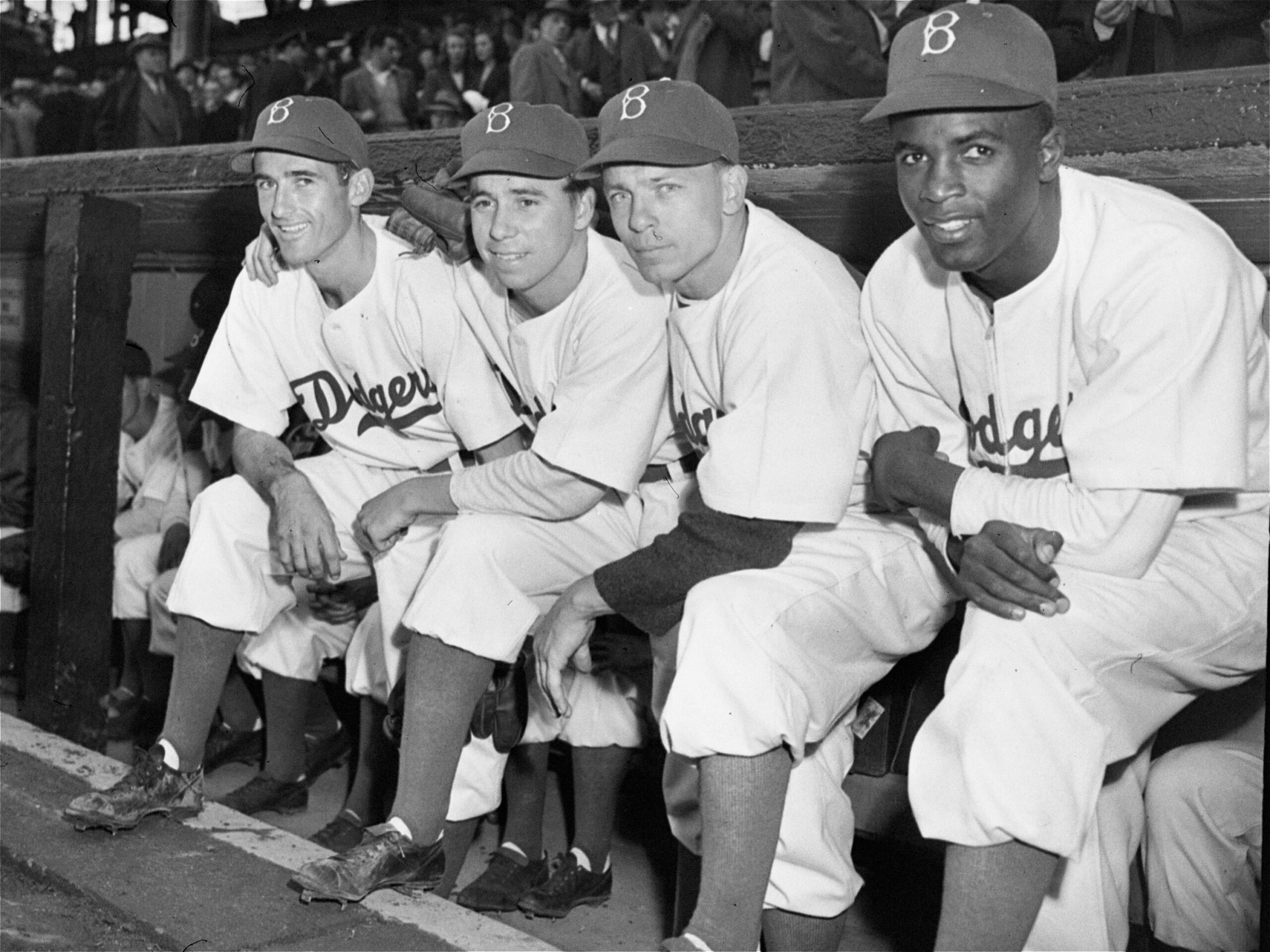 In this April 15, 1947, file photo, Brooklyn Dodgers baseball players, from left, third baseman John Jorgensen, shortstop Pee Wee Reese, second baseman Ed Stanky, and first baseman Jackie Robinson pose before the opener at Ebbets Field.