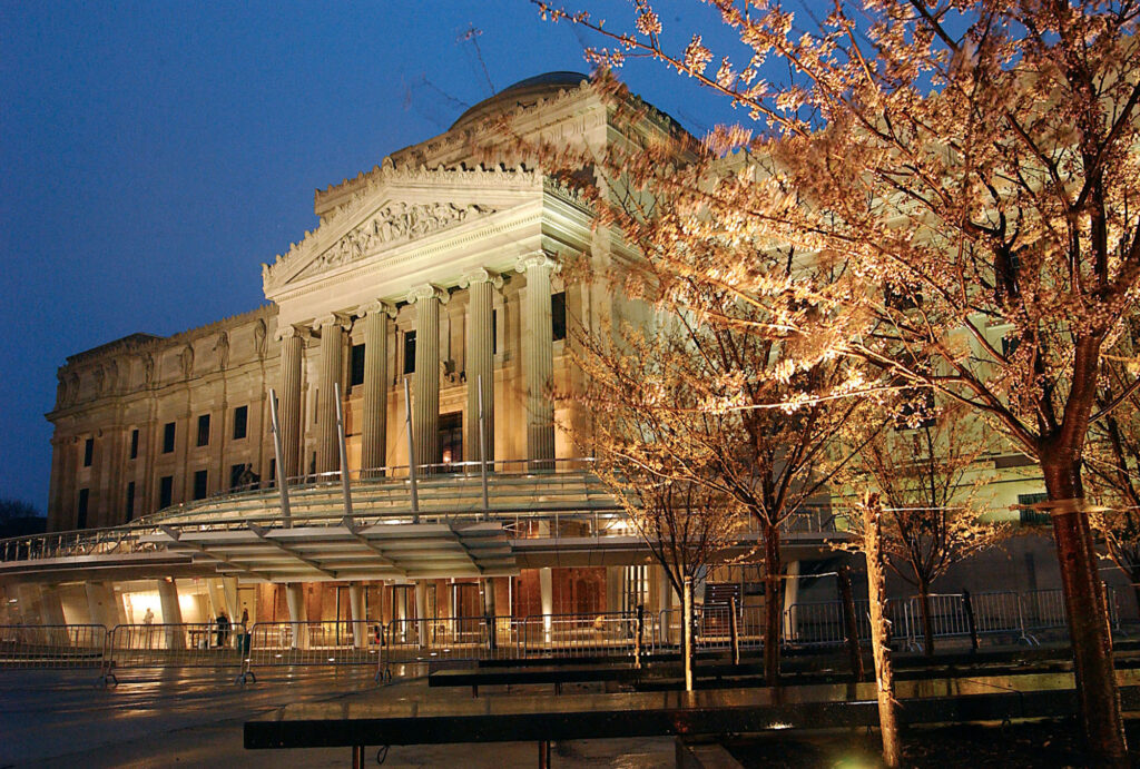 Lights at dusk brighten the cherry blossoms, the facade and the new front glass entrance and pavilion of the Brooklyn Museum of Art in the Brooklyn borough of New York, Tuesday, April 13, 2004. After two years and $63 million, the museum plans to reopen its front entrance and public plaza, Saturday. (AP Photo/Dean Cox)