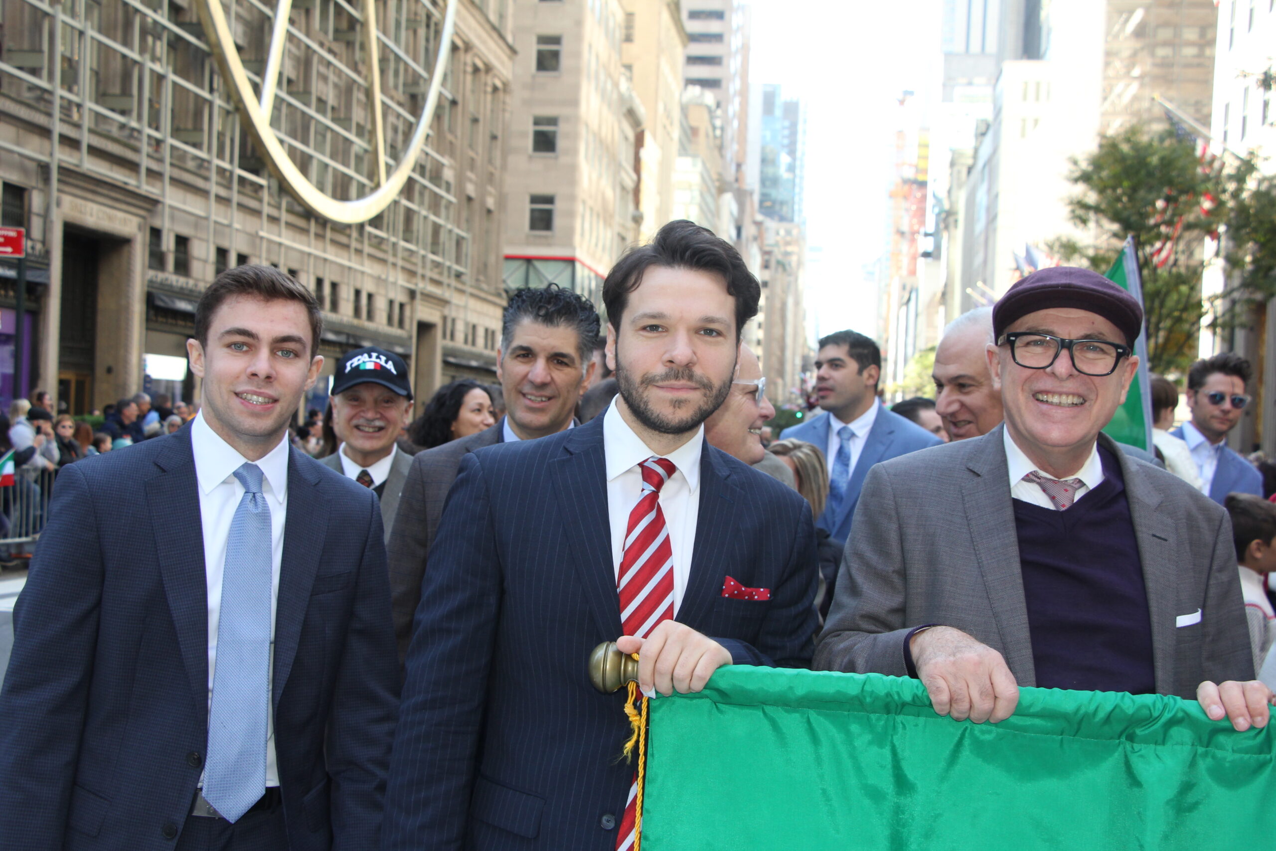 Gianni Tribuzio (center) and Vito Cannavo (right) share a stride, representing the varied faces of Brooklyn's legal sector as they march in the parade.
