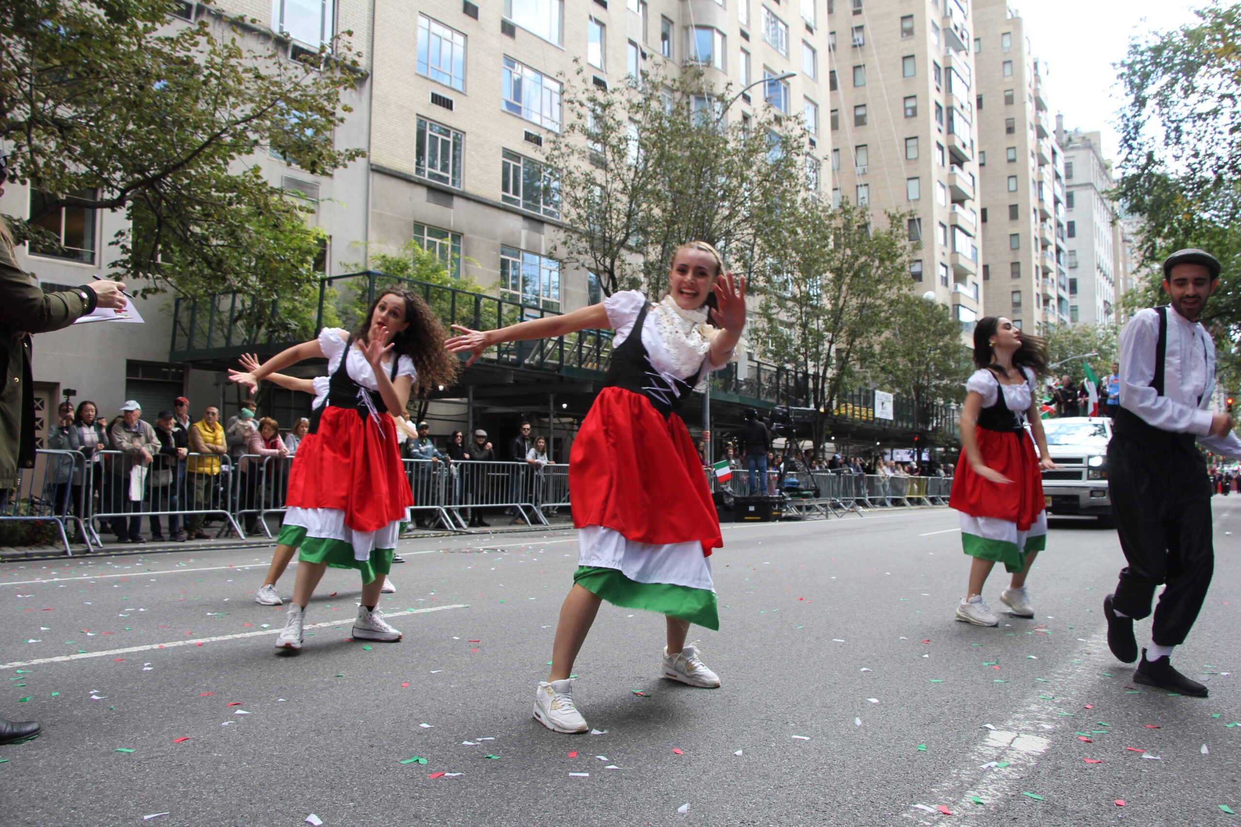 Women donned in Italian flag-colored dresses enliven the parade route, a vibrant display of Italy's cultural and aesthetic contributions to the American mosaic.