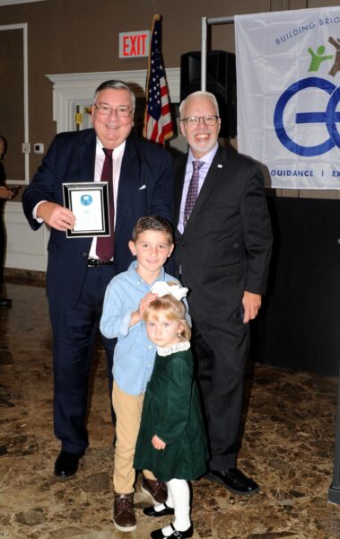 Hon. Matthew J. D’Emic (left) with his two grandchildren; and Joe Riley, executive director and CEO.