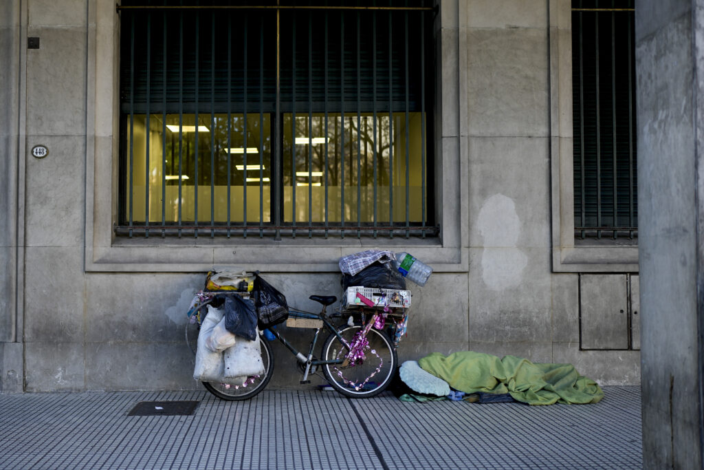 ARGENTINA — Home on wheels – street scene in Buenos Aires: A homeless person sleeps next to a bicycle in Buenos Aires, Argentina, Tuesday, Nov. 14, 2023.Photo: Natacha Pisarenko/AP
