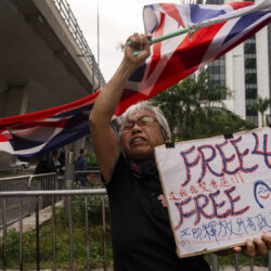 HONG KONG — A strong voice for democracy in China: A pro-democracy activist known as "Grandma Wong" protests outside the West Kowloon courts in a cordoned-off area set up by police as closing arguments open in Hong Kong's largest national security trial of 47 pro-democracy figures in Hong Kong, Wednesday, Nov. 29, 2023.Photo: Louise Delmotte/AP