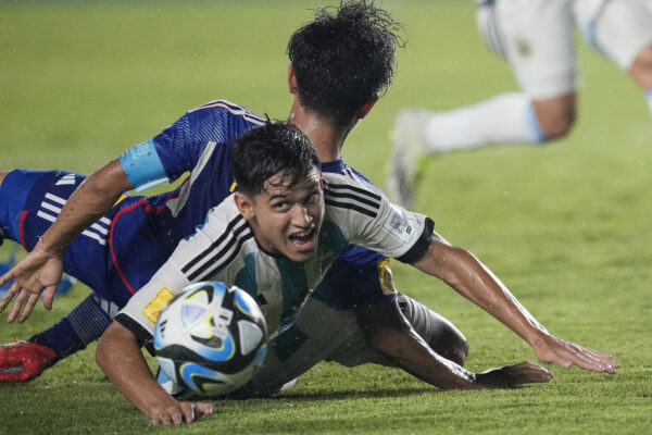 <b>INDONESIA — Battling for the ball at ground level:</b> Argentina's Dylan Gorosito, right, battles for the ball against Japan's Keita Kosugi during their FIFA U-17 World Cup Group D soccer match at Si Jalak Harupat Stadium in Bandung, West Java, Indonesia, Tuesday, Nov. 14, 2023.<br>Photo:Achmad Ibrahim/AP