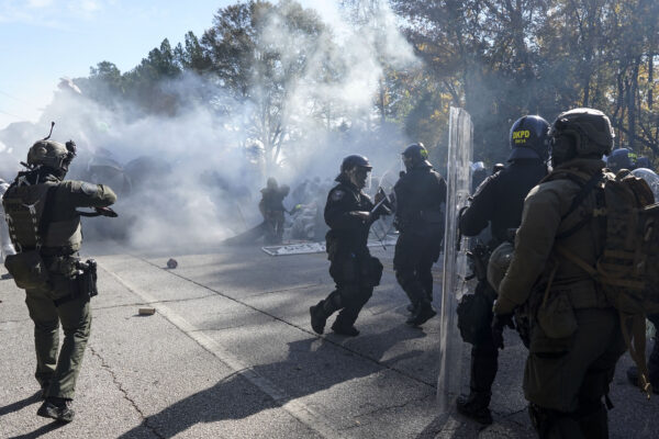 ATLANTA — Protesting ‘Cop City’ construction on site of historic forest which includes native american burial grounds: Police disperse a crowd of protesters with gas during a demonstration in opposition to a new police training center, Monday, Nov. 13, 2023, in Atlanta.<br>Photo: Mike Stewart/AP