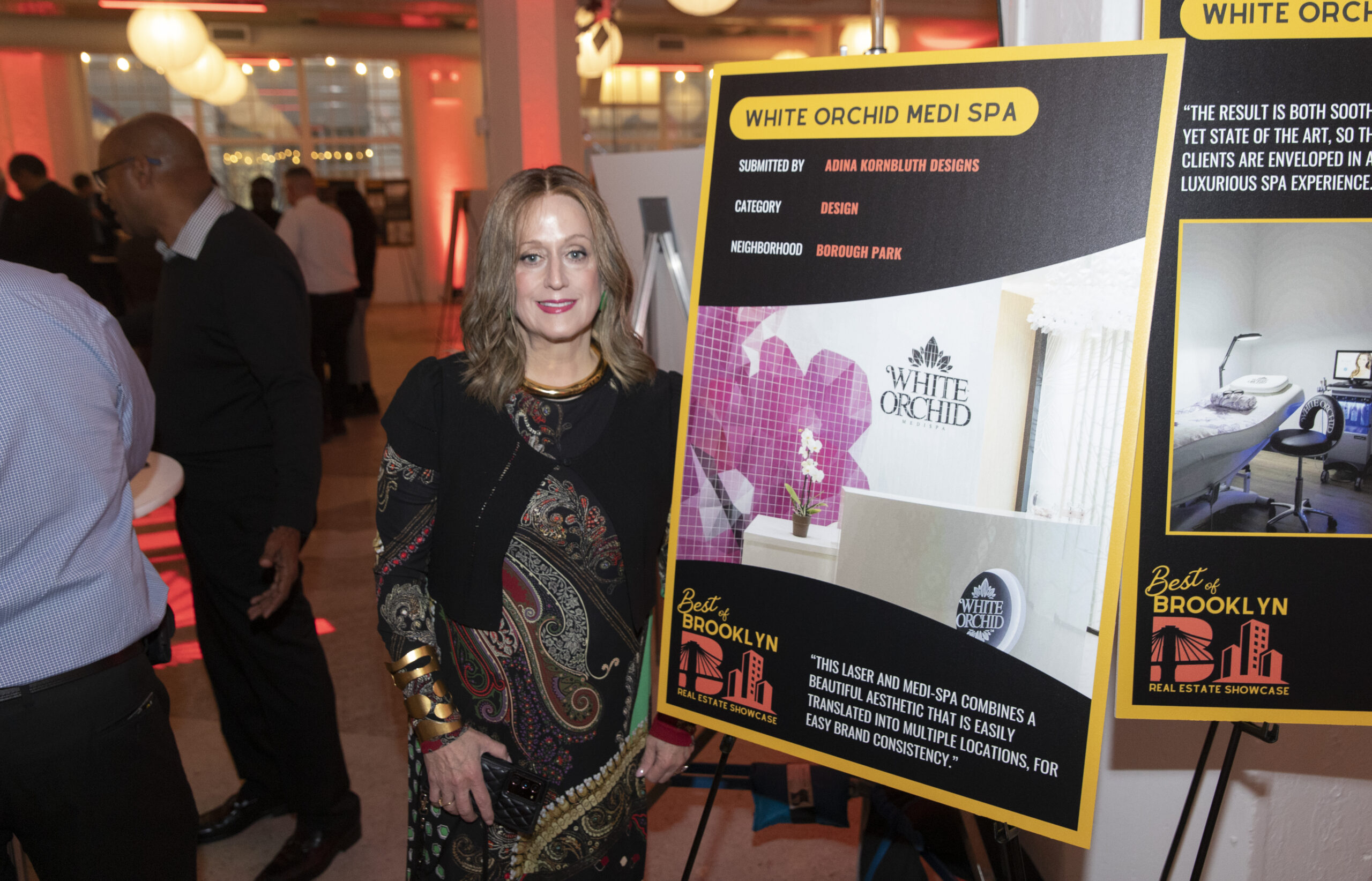 Adina Kornbluth next to her Project at Best of Brooklyn Real Estate Showcase.