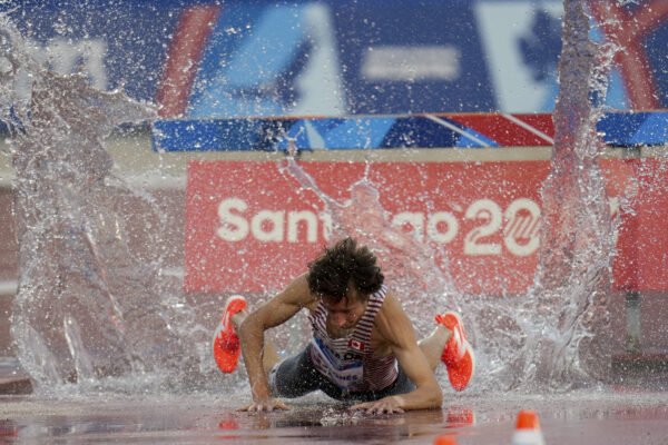<b>CHILE – Struggling with the vagaries of steeplechase:</b> Canada's Jean-Simon Desgagnes falls in the men's 3000-meters steeplechase final at the Pan American Games in Santiago, Chile, Saturday, Nov. 4, 2023.<br>Photo: Fernando Vergara/AP