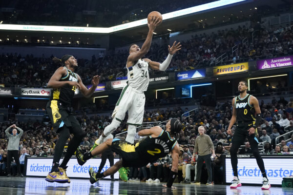 <b>INDIANAPOLIS – ‘DON’T FOUL ME I’M FLYIN’...’</b> Indiana Pacers' Andrew Nembhard (2) defends as Milwaukee Bucks' Giannis Antetokounmpo (34) goes up for the basket during the second half of an NBA basketball game, Thursday, Nov. 9, 2023, in Indianapolis. Nembhard was called for a blocking foul on the play.<br>Photo: Darron Cummings/AP