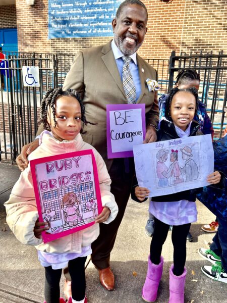 State Sen. Kevin Parker with students who this week paid tribute to Ruby Bridges’ first day at a newly-desegregated school 63 years ago for Walk to School Day. Photo courtesy Office of State Senator Kevin Parker