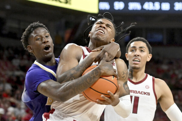 <strong>ARKANSAS — ‘Gimme the ball, gimme the ball, gimme the ball’:</strong> Arkansas guard Khalif Battle, center, is fouled by Alcorn State forward Willie Anderson Jr., left, as he drives to the hoop during the second half of an NCAA college basketball game Monday, Nov. 6, 2023, in Fayetteville, Ark. Anderson was charged with a flagrant foul on the play.<br>Photo: Michael Woods/AP