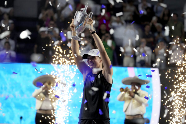 <strong>CANCUN — ‘Why can’t we have trumpet players at Wimbledon?’:</strong> Iga Swiatek, of Poland, holds up her trophy after her victory over Jessica Pegula, of the United States, in the women's singles final of the WTA Finals tennis championships, in Cancun, Mexico, Monday, Nov. 6, 2023.<br>Photo: Fernando Llano/AP