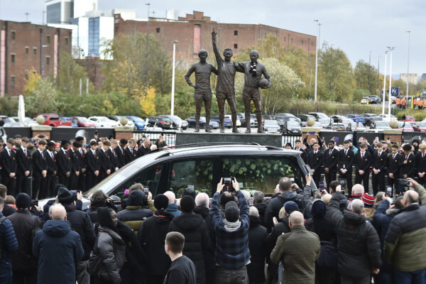 MANCHESTER — The body of soccer icon passes his statue: The cortege of English soccer icon Bobby Charlton passes by the statue of Manchester United trio of George Best, left, Denis Law, center, and Sir Bobby Charlton outside Old Trafford stadium on its way to the funeral service at Manchester Cathedral in Manchester, England, Monday, Nov. 13, 2023. Charlton, who played largely for Manchester United, survived a plane crash that decimated a United team destined for greatness. He went on to become the heartbeat of his country's 1966 World Cup triumph.<br>Photo: Rui Vieira/AP