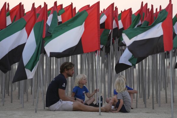 DUBAI — A day at the beach, indeed Flag Day in an oil-rich country not currently at war: People sit under UAE flags, six thousand of which are put on display to celebrate the country's Flag Day in Dubai, United Arab Emirates, Saturday, Nov. 4, 2023. The Emirates Flag Day is officially on Nov. 3. Photo: Kamran Jebreili/AP