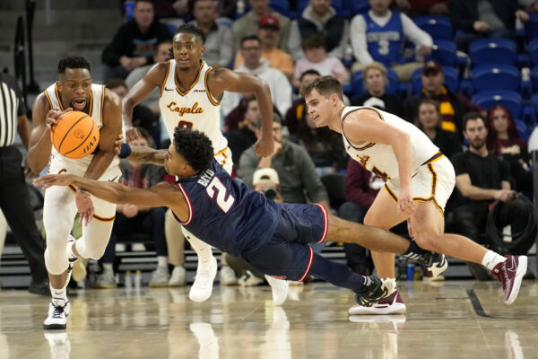 <b>CHICAGO — Three on one? Go horizontal:</b> Florida Atlantic's Nicholas Boyd (2) loses control of the ball to Loyola's Patrick Mwamba as Braden Norris also defends during the second half of an NCAA college basketball game Wednesday, Nov. 8, 2023, in Chicago. Florida Atlantic won 75-62.<br>Photo: Charles Rex Arbogast/AP