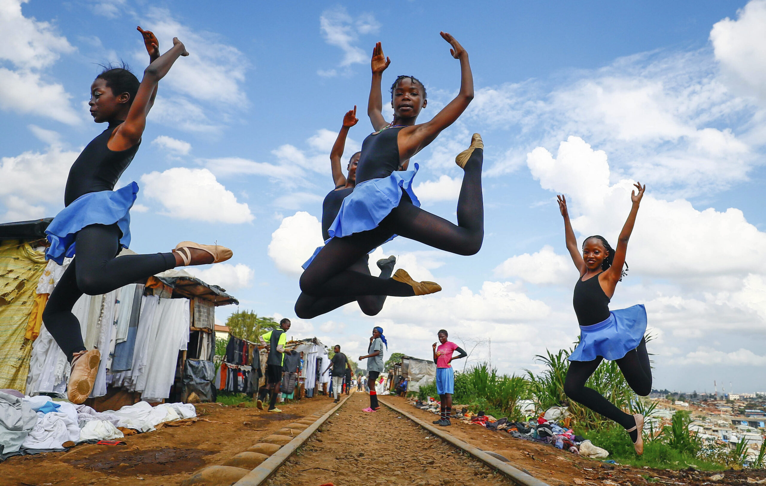 NAIROBI — Leaping for beauty, art and hope for the future: Young girls practice by the Kenya - Uganda railway line prior to the start of a Christmas ballet, in Kibera, one of the busiest neighborhoods of Kenya's capital, Nairobi, Friday, Dec. 15, 2023. The ballet project is run by Project Elimu, a community-driven nonprofit that offers after-school arts education and a safe space to children in Kibera.Photo: Brian Inganga/AP