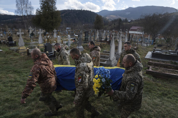 <b>UKRAINE — More sad scenes from a war zone:</b> Ukrainian servicemen carry the coffin of their comrade Vasyl Boichuk who was killed in Mykolayiv in March 2022, during his funeral ceremony at the cemetery in Iltsi village, Ukraine, Tuesday, Dec. 26, 2023.<br>Photo: Evgeniy Maloletka/AP