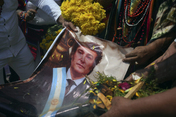 <b>LIMA — Ritual of political predictions, not constant on cable TV, but once a year:</b> Shamans hold a photo of Argentina's President Javier Milei as they perform an annual ritual to predict political and social issues for the new year, on the top of San Cristobal hill in Lima, Peru, Wednesday, Dec. 27, 2023.<br>Photo: Guadalupe Pardo/AP