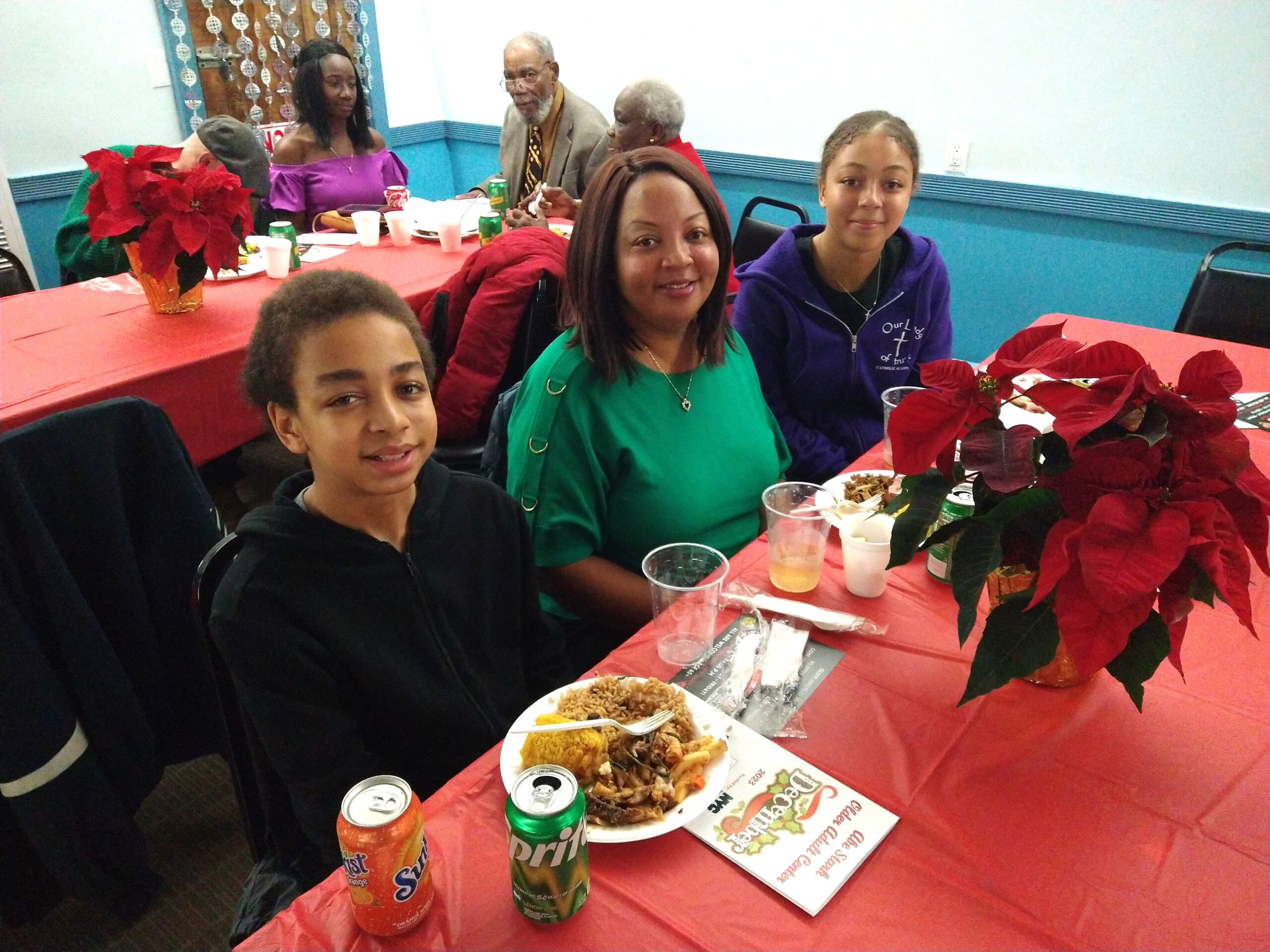 Patrons enjoying food and drink at the Midget Squadron Yacht Club for 69th Precinct Community Council’s annual holiday celebration.