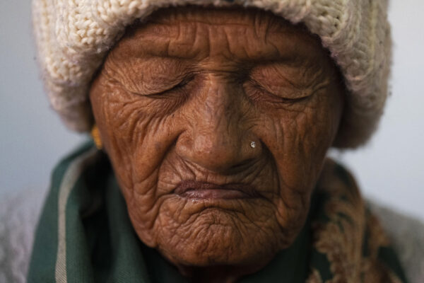 <b>NEPAL — Private Christmas prayers:</b> An elderly woman offers prayers at a church on Christmas in Kathmandu, Nepal, Monday, Dec. 25, 2023.<br>Photo: Niranjan Shrestha/AP