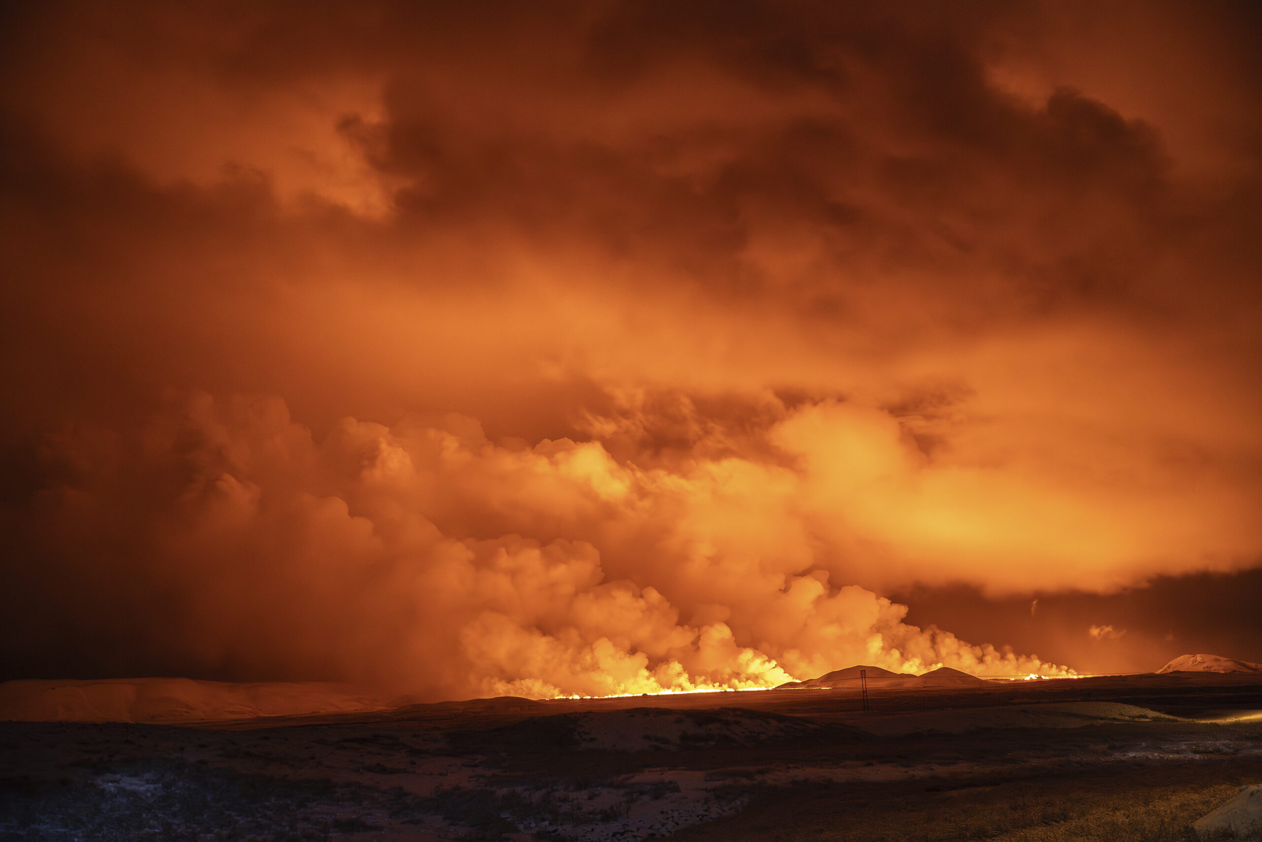 ICELAND — Mother Earth, the power within: The night sky is illuminated caused by the eruption of a volcano in Grindavik on Iceland's Reykjanes Peninsula, Monday, Dec. 18, 2023.Photo: Marco Di Marco/AP