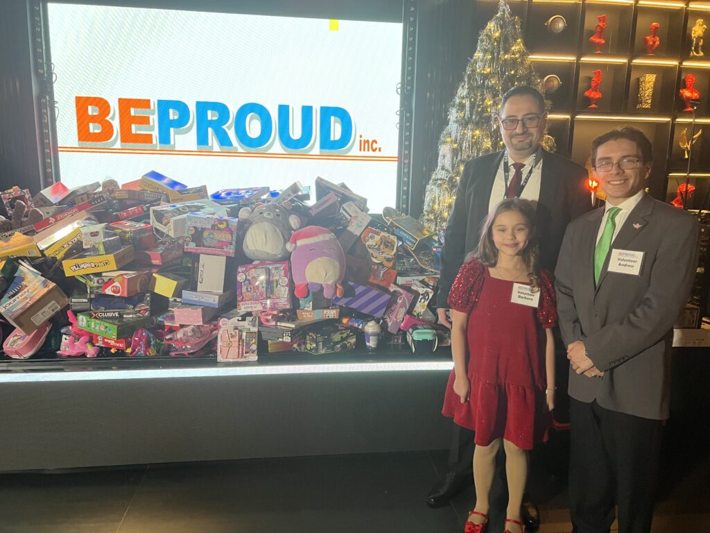 Alex Zhorov, president of Be Proud Inc. (left), along with Be Proud volunteers Barbara Oterin, age 9, and Andrew Contrino at Toys for Tots event. Photos: Wayne Daren Schneiderman/Brooklyn Eagle