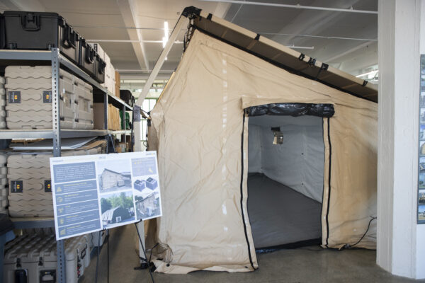 An example of the equipment manufactured in the space. This tent structure made of solar collecting material could contain electronic equipment for a rock band or a military operation in the desert at Pvilion ribbon cutting.