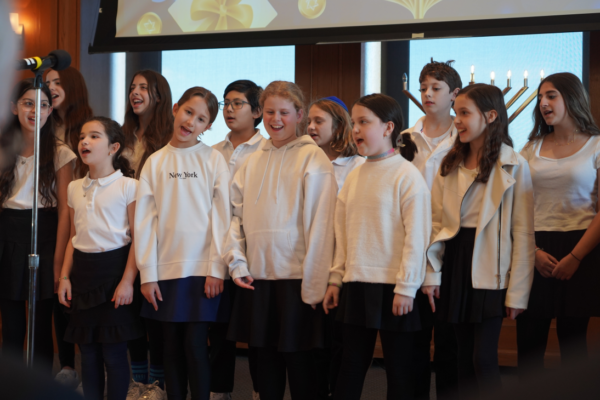 The middle school students from Ramaz Middle School captivate the audience with their enchanting holiday songs during the DA’s Office annual Hanukkah Celebration.