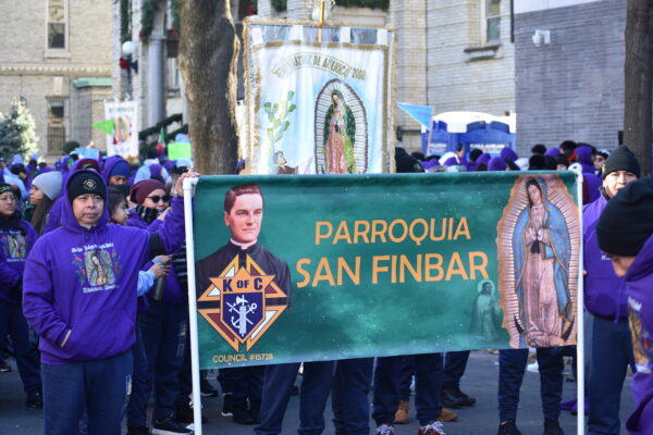 Members of St. Finbar parish in Bath Beach carry their banner as they begin their procession.<br>Photo courtesy DeSales Media