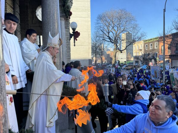 The bishop and auxiliary bishops light the torches to be carried to parishes around the BrooklynPhoto courtesy DeSales Media